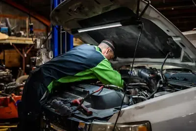 diesel mechanic working on a truck engine