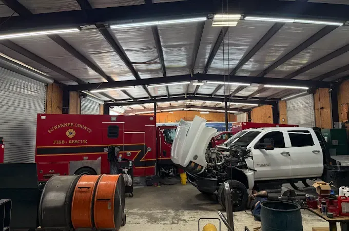 Fire engine and pickup truck in the service bays at Southern Specialized in Lake City, FL